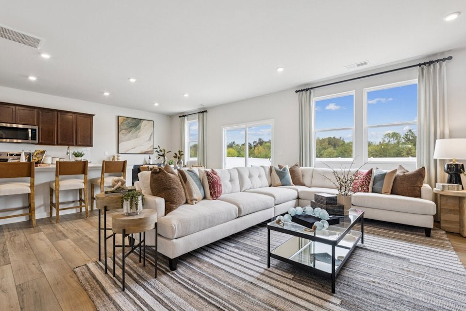 Living space at Meadow Creek Village Meadow Creek Village open living space with tall ceilings and windows