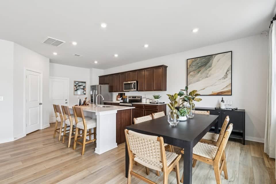 Open-concept kitchen and dining at Meadow Creek Village Meadow Creek Village open-concept kitchen and dining area